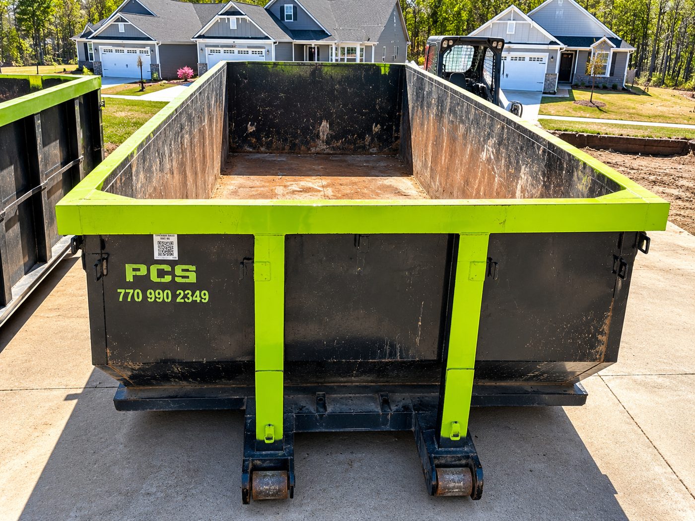 Empty Pablo's Clean Up Services roll-off container ready for delivery